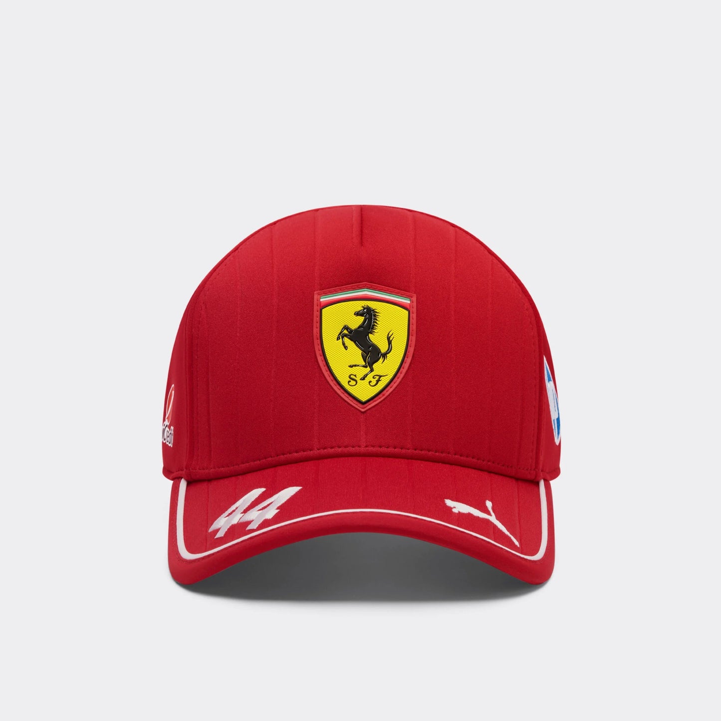 A red baseball cap with the Scuderia Ferrari logo, featuring a yellow shield with a black horse, and the PUMA Jumping Cat logo.