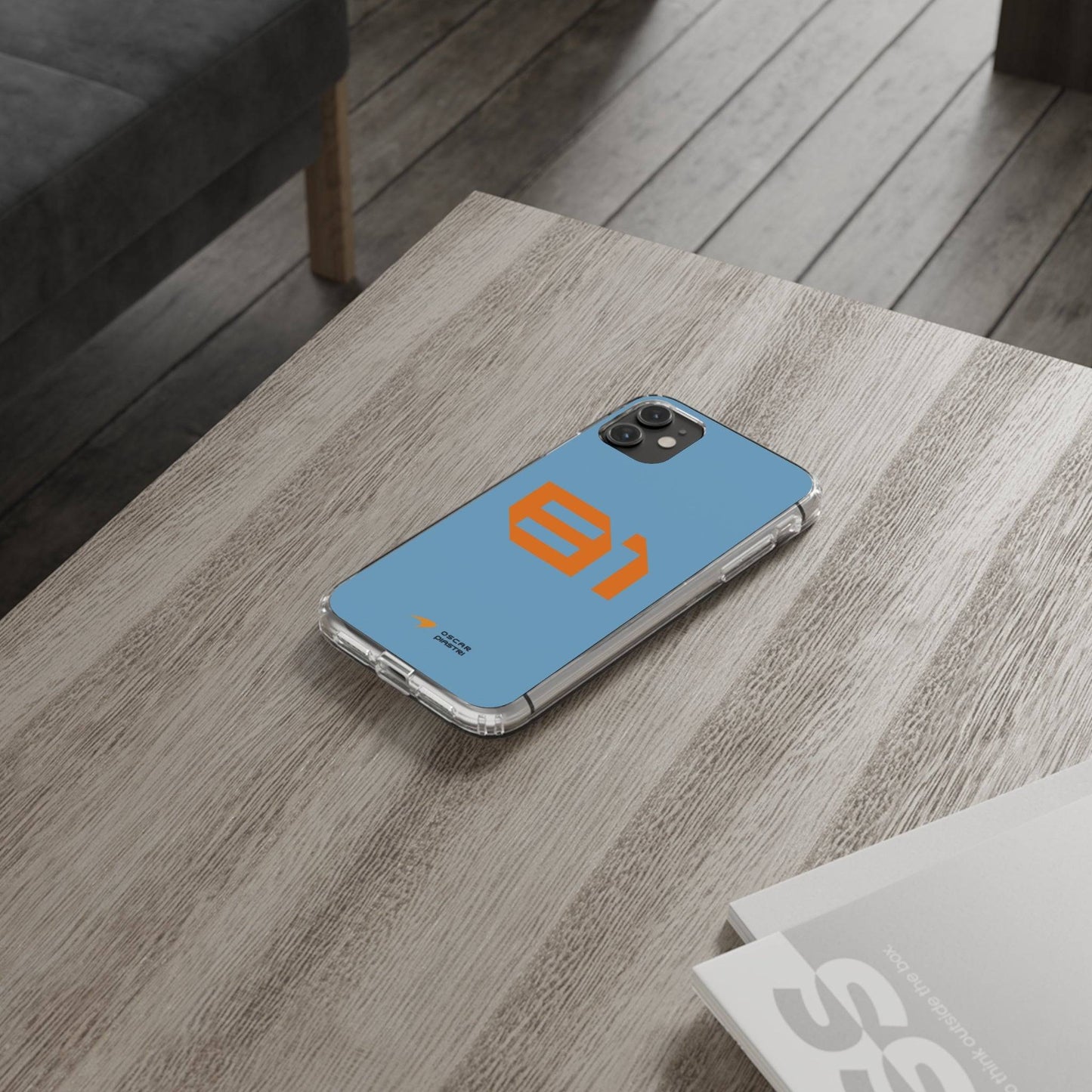 Oscar Piastri #81 iPhone cover on wooden table