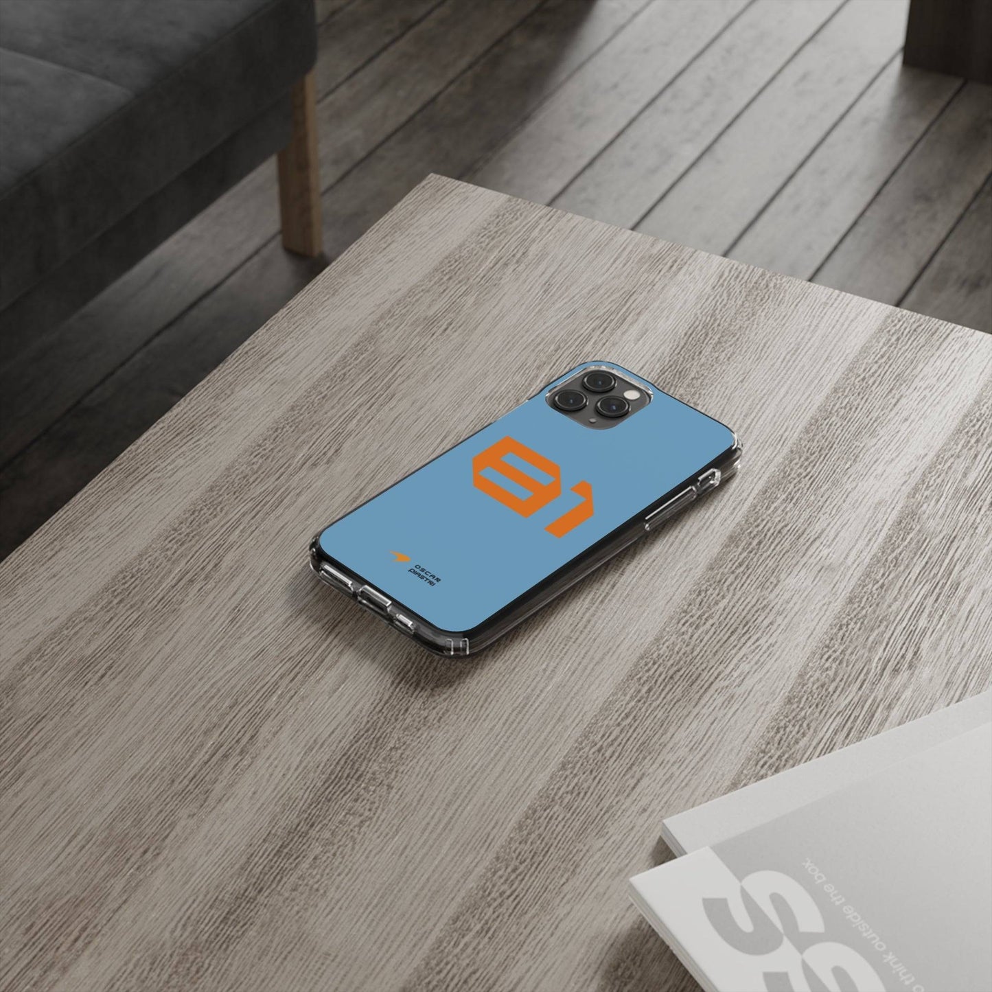 Oscar Piastri #81 iPhone cover on wooden table