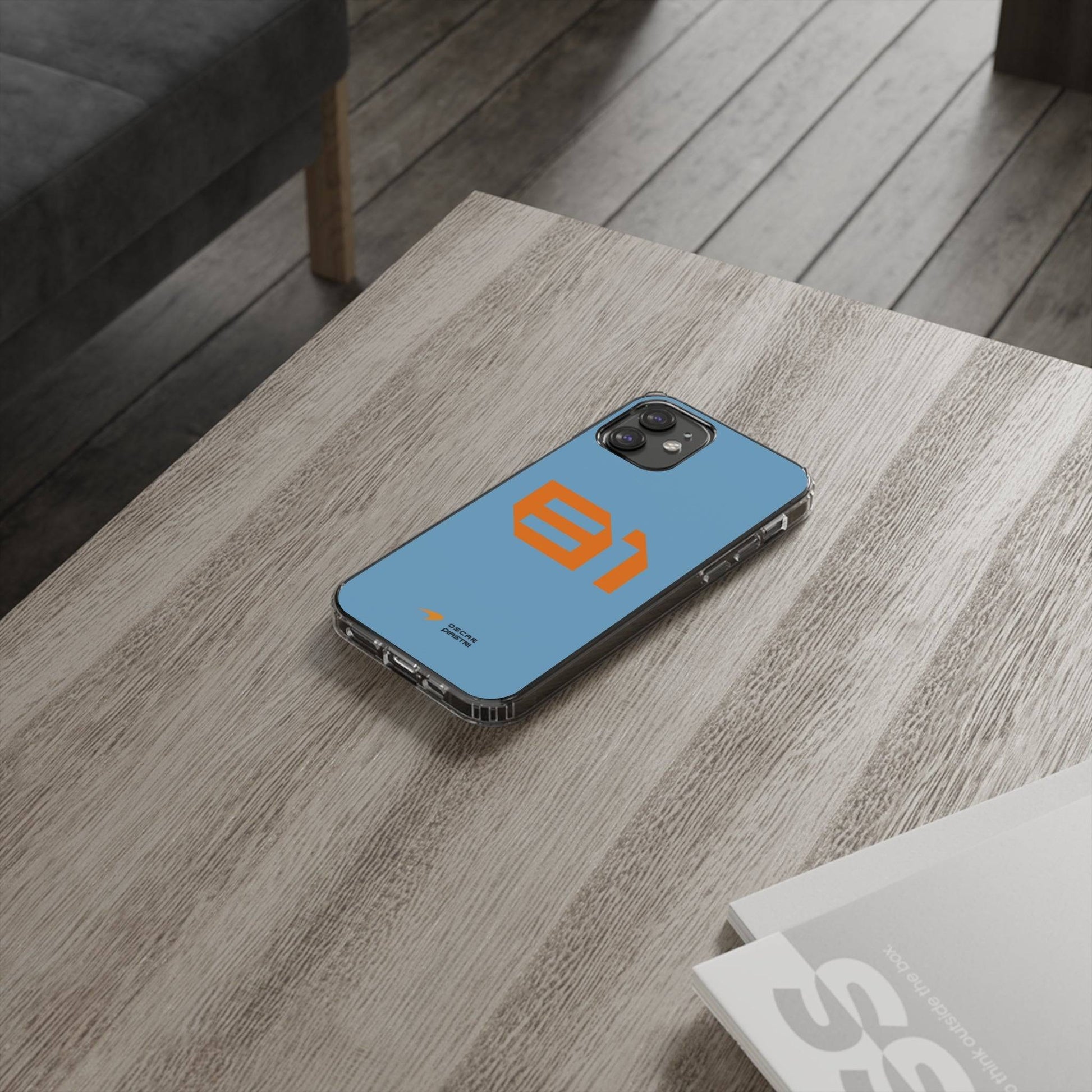 Oscar Piastri #81 iPhone cover on wooden table